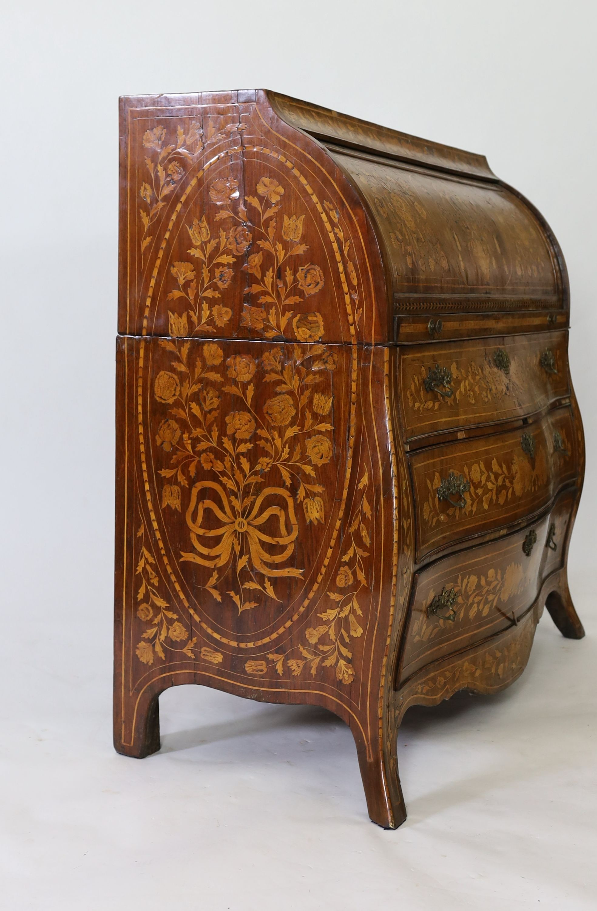 An early 19th century Dutch walnut and floral marquetry bombe cylinder bureau, W.133cm D.58cm H.122cm